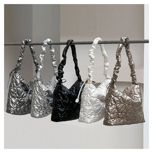 Detailed row of five quilted heart-pattern shoulder bags in metallic color options