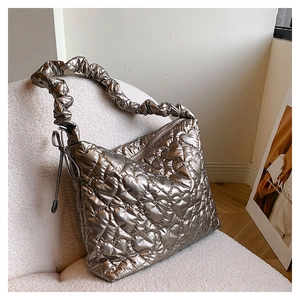 Detail of champagne gold heart quilted bag featuring a trendy ruffled scrunchie strap