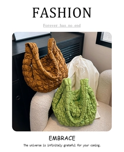 Detail view of quilted cloud crossbody bags in caramel brown and lime green colors