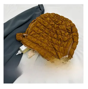 Brown quilted puff shoulder bag showing large capacity with daily essentials and tablet