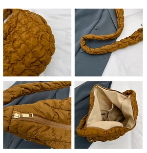 Detail view of brown quilted cloud bag showing texture, zipper, strap and inner pocket