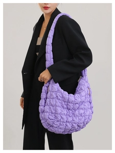 Detail of purple quilted bubble fabric and cloud pleated texture on the crossbody bag