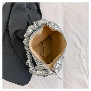 Interior view of silver quilted tote bag with brown lining and secure zipper closure