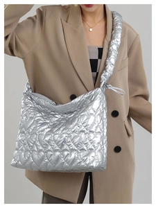 Detail of silver metallic tote bag with heart quilting and puffy shoulder strap