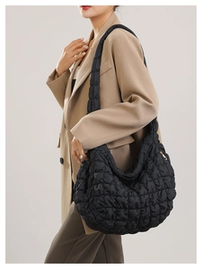 Macro view showing the quilted texture and soft fabric of this cloud shoulder bag