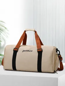 Detail view of khaki travel bag showing separate zipper compartment and canvas texture