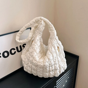 Quilted cloud puffy shoulder bag in white with elegant gold zipper and wide strap