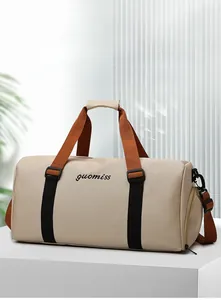 Detail of multi-functional oxford travel tote with orange handles and independent shoe pocket