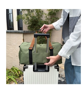 Detail of army green travel tote with luggage handle sleeve for gym and weekend trips