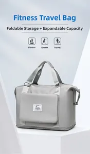 Detail view of grey fitness travel bag featuring expandable zipper and logo patch