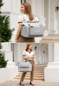 Gray large capacity travel bag showing expandable zipper base and dual shoulder straps