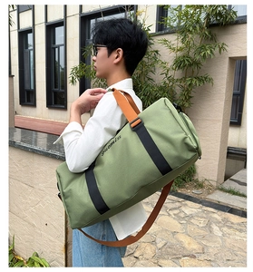 Outdoor lifestyle shot of a large green Oxford tote bag with orange handles