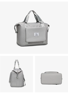 Detalle de bolsa de deporte gris con asas reforzadas y base expandible con cremallera