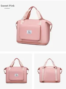 Sweet Pink large capacity foldable travel bag featuring front zip pocket and reinforced straps