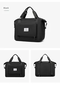 Detail view of the black nylon gym bag featuring a trolley sleeve and front zipper pocket