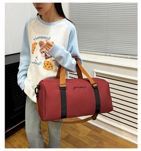 Detail view of large burgundy oxford tote bag with side shoe compartment and logo