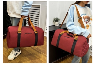 Detail of burgundy oxford gym tote bag showing dual handles and adjustable shoulder strap