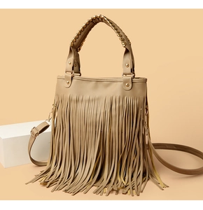 Dettaglio borsa a mano kaki con frange in pelle stile boho e borchie dorate lucide