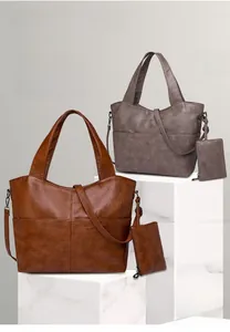 Detail of vintage faux leather tote set with hanging pouch and long shoulder straps
