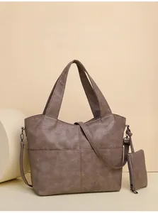 Detail of large capacity brown leather tote bag with multi-compartments and waterproof fabric