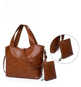 Close-up of brown litchi pattern leather handbag with detachable coin purse attachment