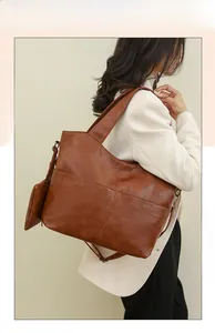 Brown faux leather tote bag with vertical stitching and detachable coin purse