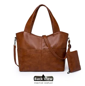 Rear view detail of brown leather tote bag with back pocket and zipper pouch
