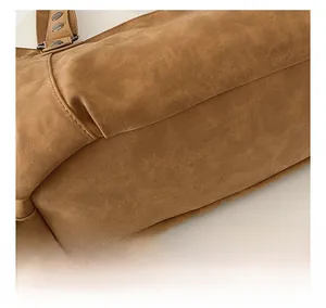 Macro detail of brown frosted suede tote bag showing soft texture and fine stitching