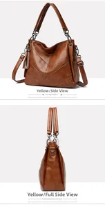Detail view of caramel brown handbag featuring V-shape stitching and side tassel decor