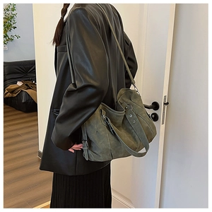 Detail view of large dark olive hobo bag with contrast stitching and matte texture