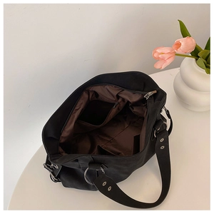 Interior view of black canvas tote bag showing brown lining and functional compartments