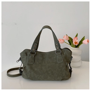 Detail of dark olive green matte tote bag with metal rings and detachable strap