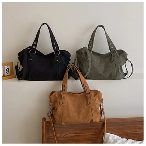 Three-color variety of matte tote bags in black, green, and brown with vintage hardware