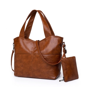 Brown vintage faux leather tote bag with crossbody strap and matching small pouch