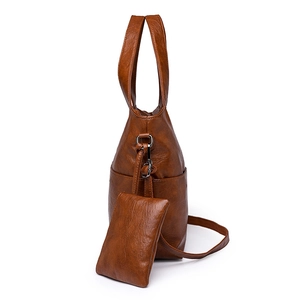 Brown leather tote bag with side pocket and matching small coin purse pendant