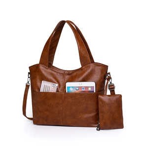 Retro brown faux leather tote bag with double pockets and matching zip pouch on white background
