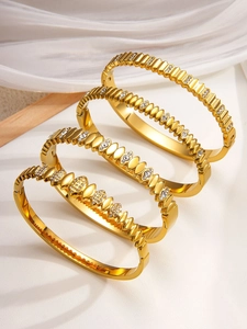 Set of four 18k gold plated stainless steel bangles with crystal inlay on fabric