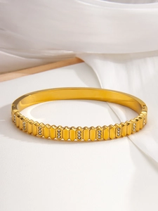 Macro detail of gold-plated checkered bracelet with cubic zirconia inlays
