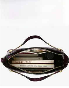 Detailed interior of purple embossed leather tote bag showing large capacity for essentials