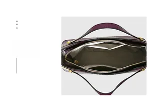 Detailed interior of purple embossed tote bag featuring compartments and gold zippers