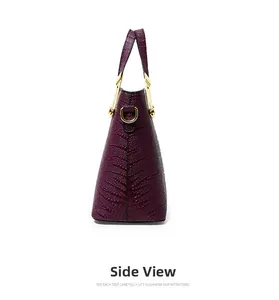 Side view of purple crocodile pattern handbag featuring gold hardware and triangular structure