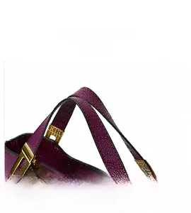 Detail show of purple crocodile embossed leather texture with elegant gold metal hardware