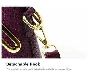 Detail of dark purple crocodile texture bag with gold metal hardware and detachable strap