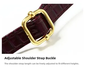 Detail of adjustable purple crocodile embossed shoulder strap with gold metal buckle