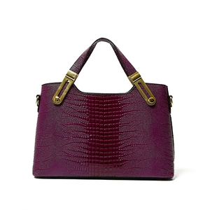 Deep purple faux crocodile leather handbag with elegant embossed texture and gold accents
