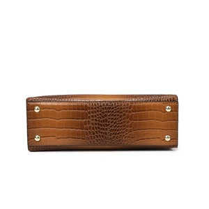 Bottom view of brown crocodile embossed leather handbag with golden metal feet