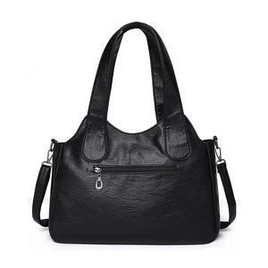 Minimalist black pebble leather tote bag with silver front zipper and dual handles