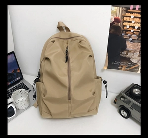 Detail view of khaki large backpack with side drawstring pockets and zip compartment