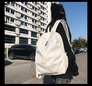Rear view of a white minimalist large-capacity backpack on model during daily outdoor use
