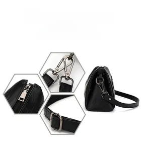 Détails de la texture du cuir et des ferrures en métal foncé sur le sac à bandoulière noir
